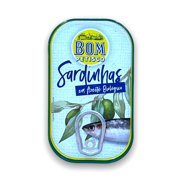 A can of Bom Petisco Sardinhas, which are organic sardines, with a blue and green label featuring an image of the sardines and leaves.